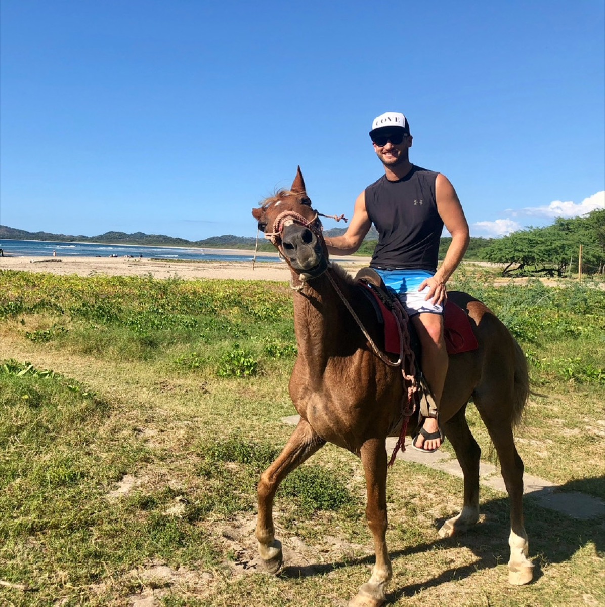 Zac horseback riding on beach in Costa Rica - sober adventure travel