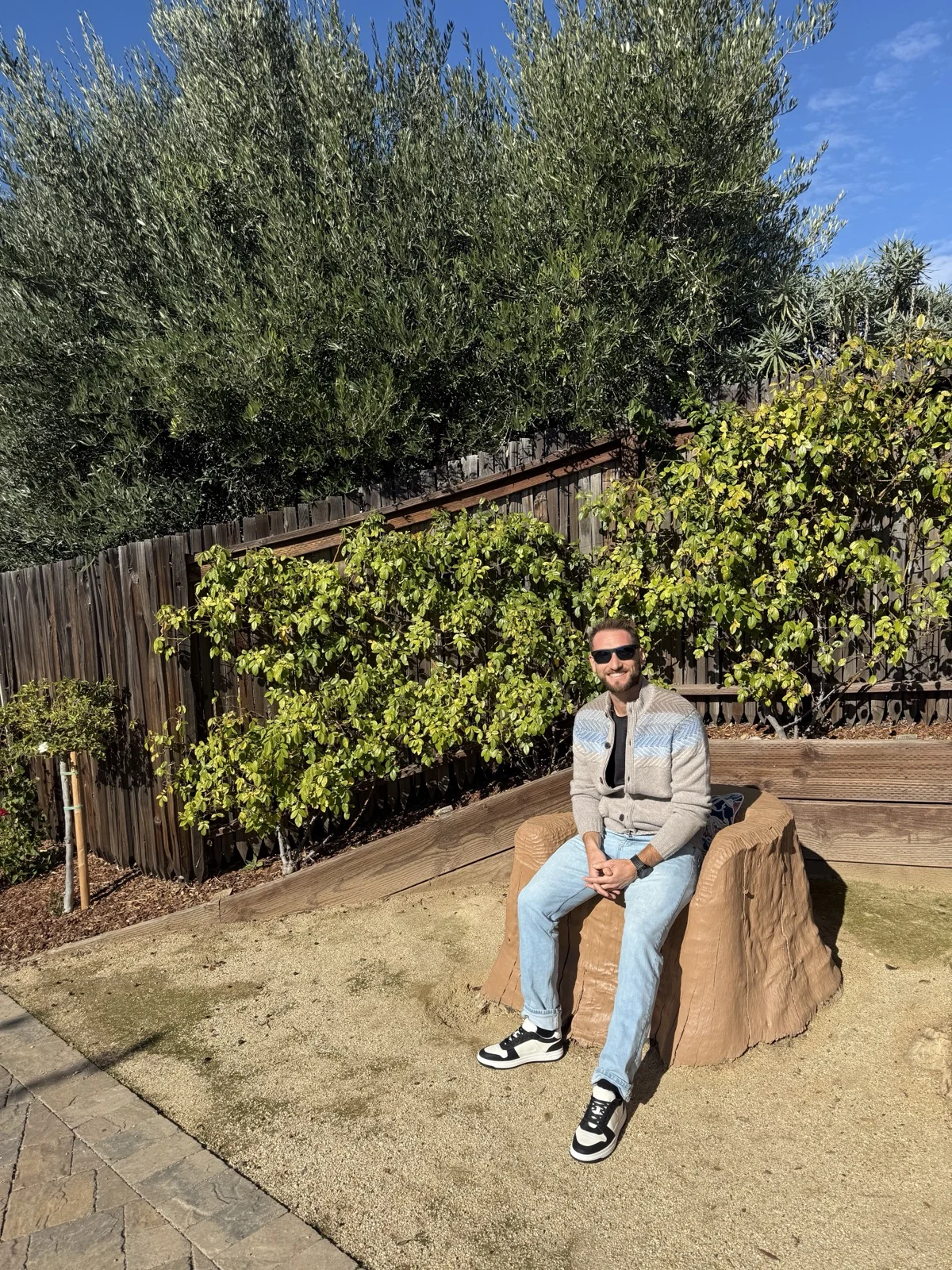 Grounded and present, no drink required. | Zac Spowart sitting calmly outdoors in the sun, on managing anxiety without alcohol, Nomadic Addictt.